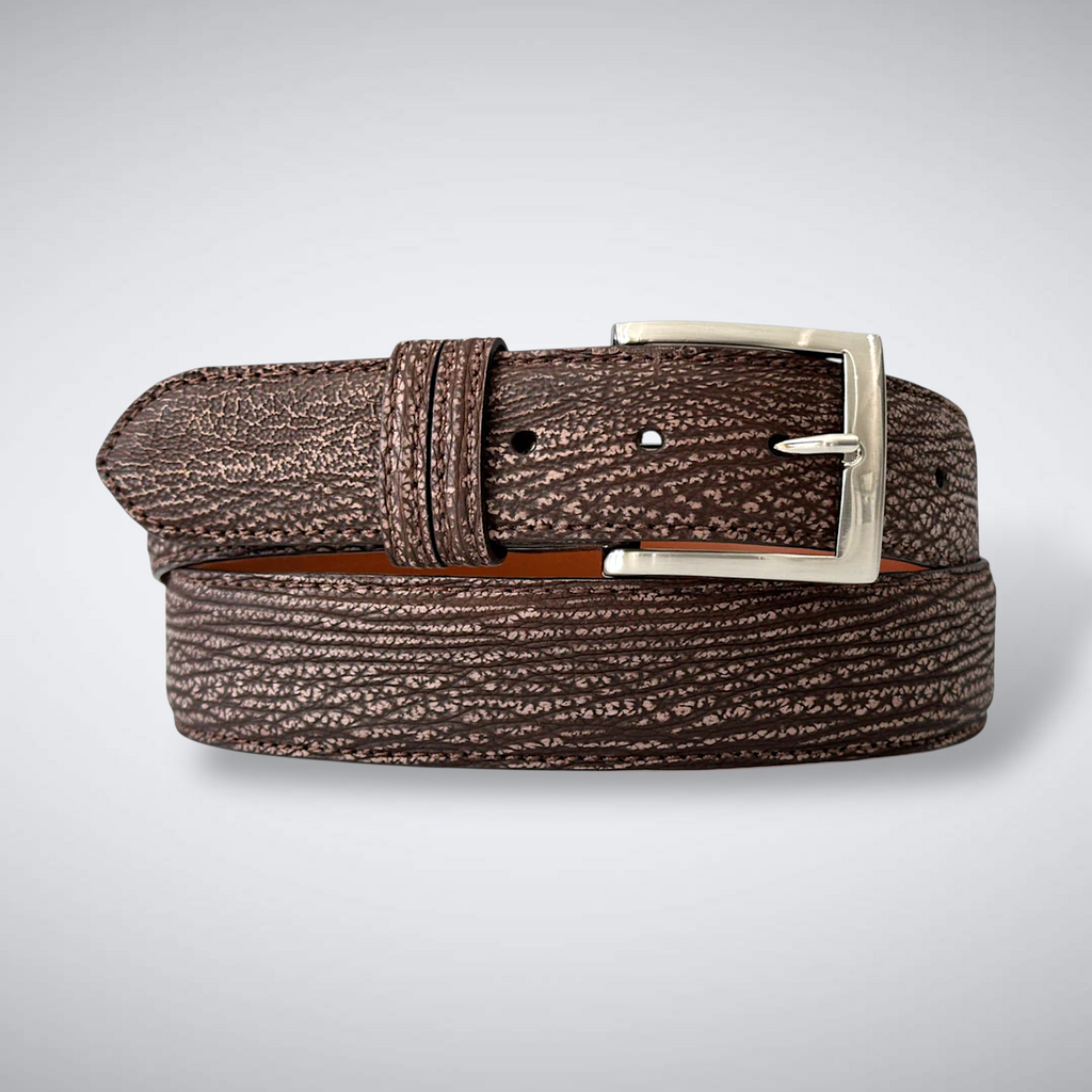 Brown textured belt with a silver buckle on a light gray background