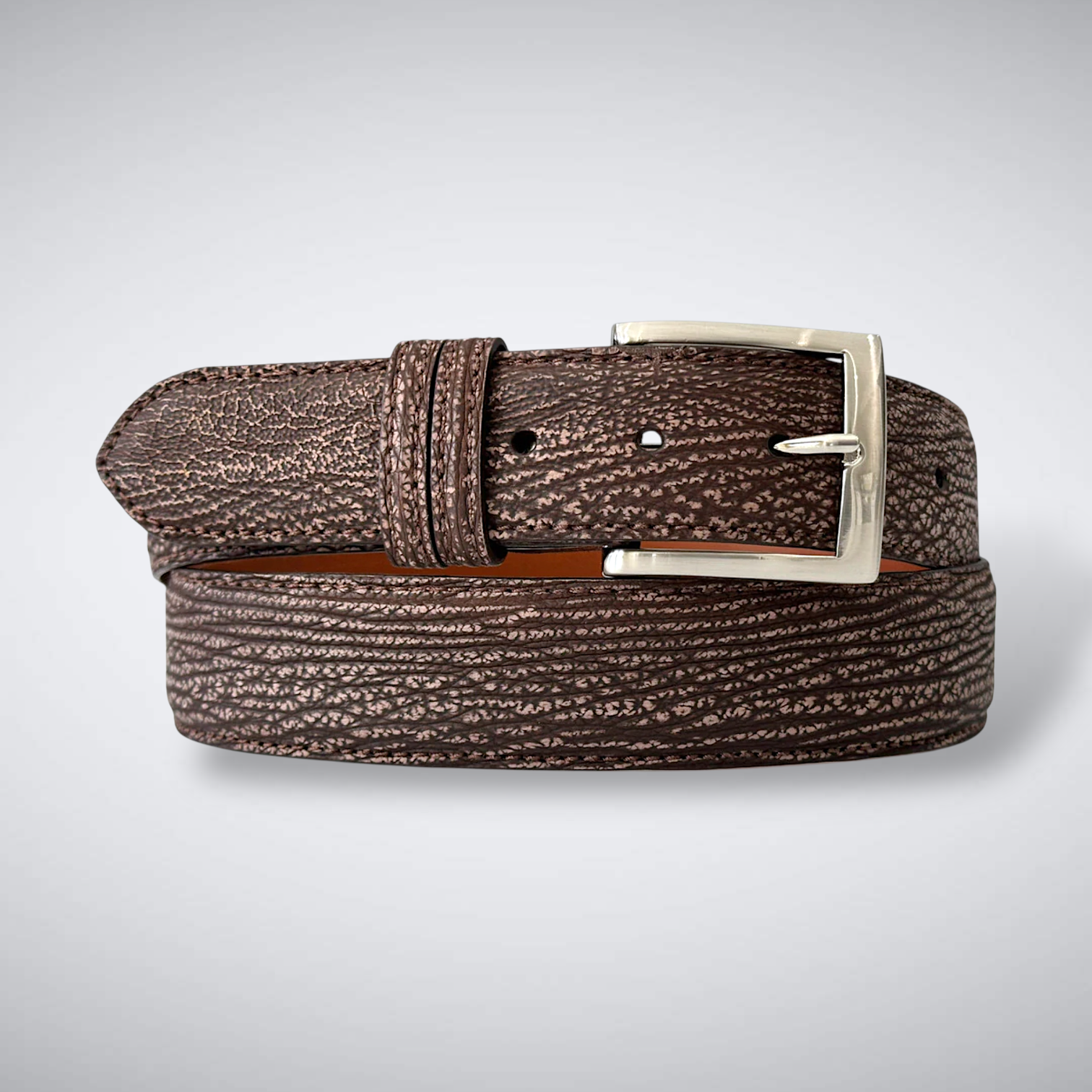 Brown textured belt with a silver buckle on a light gray background